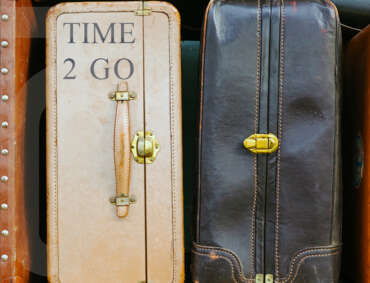 time to go - stack of suitcases