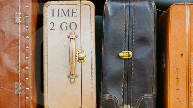 time to go - stack of suitcases