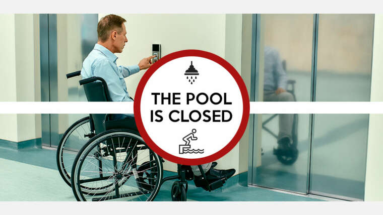 Man in wheelchair calling for an elevator